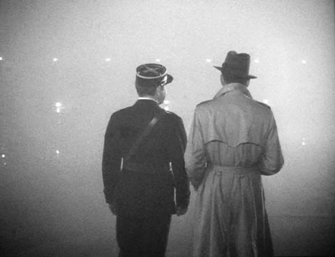 two men standing in the street